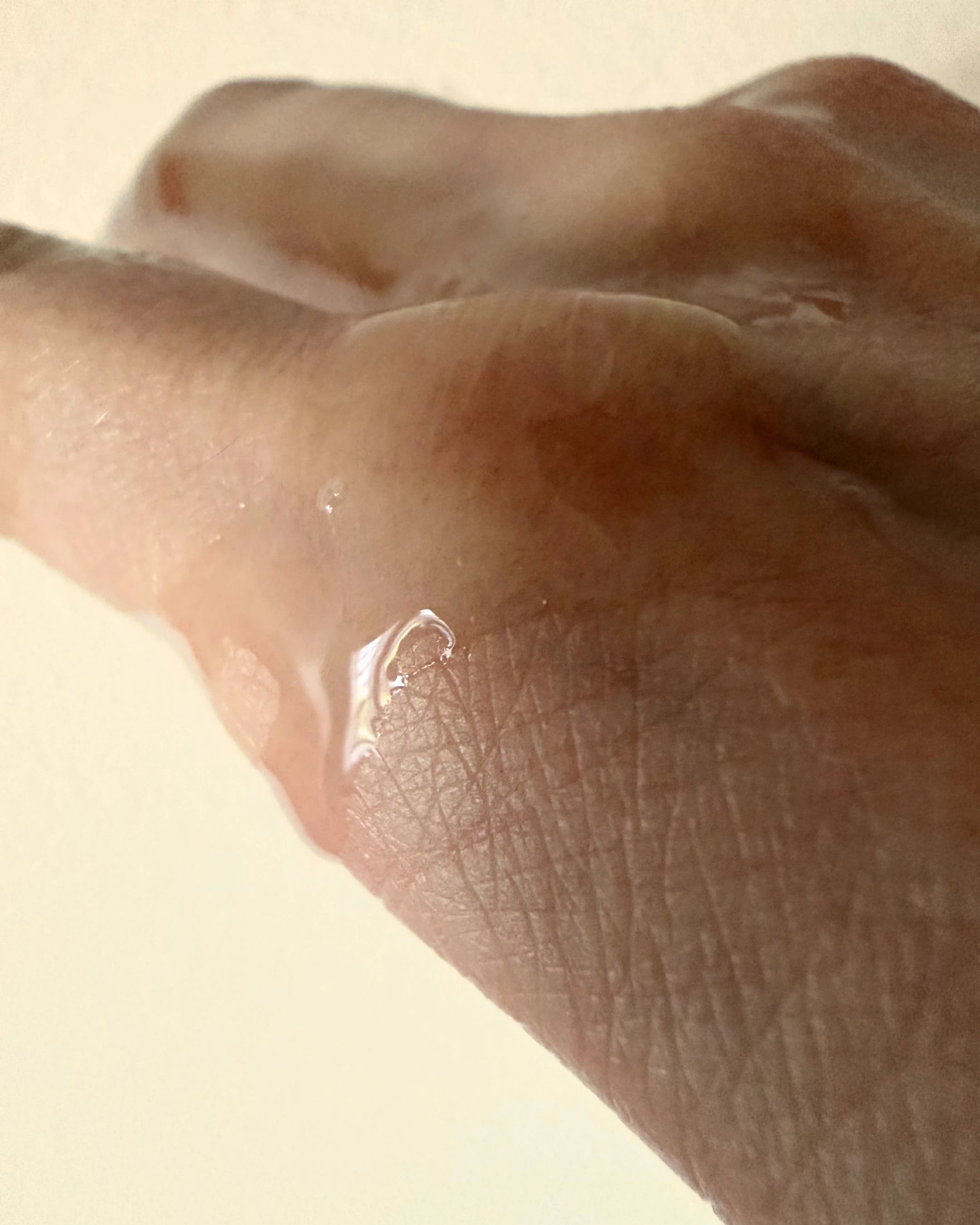 A closeup image of skin with serum on it