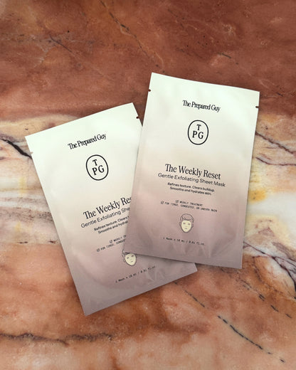 Two sheet mask packages on brown marble